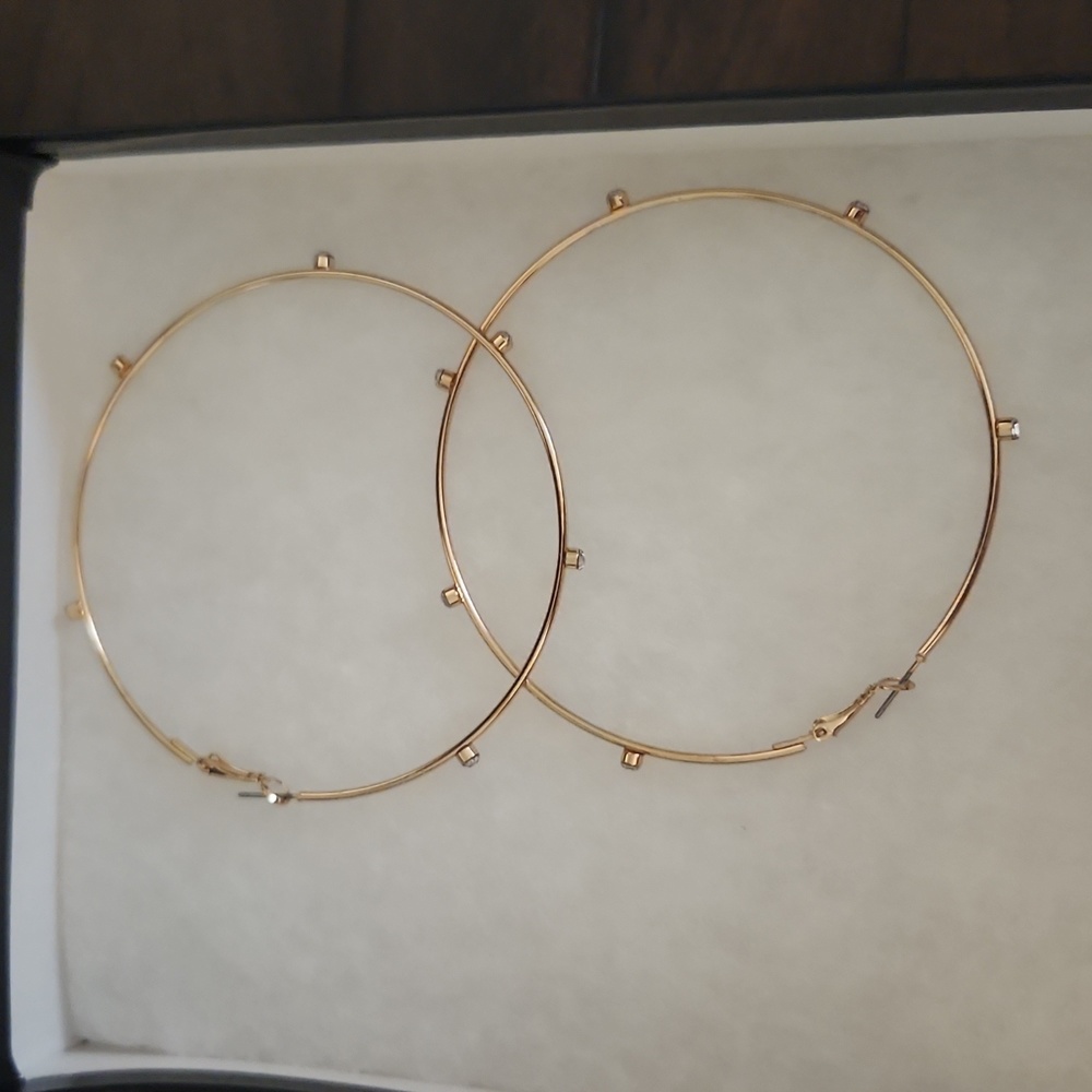 Gold hoops with crystal gems around them